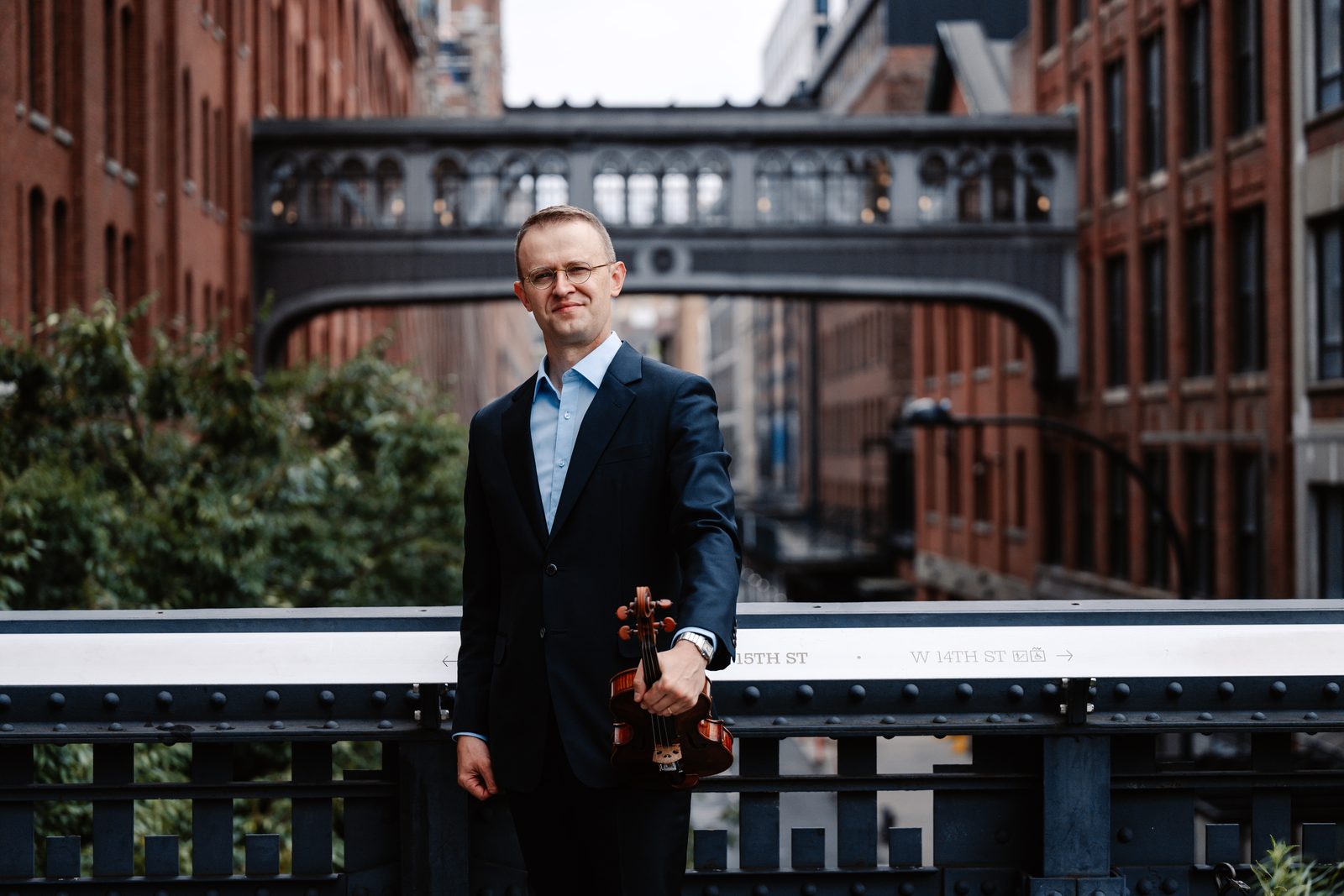 David Southorn holding his violin on the High Line in New York City