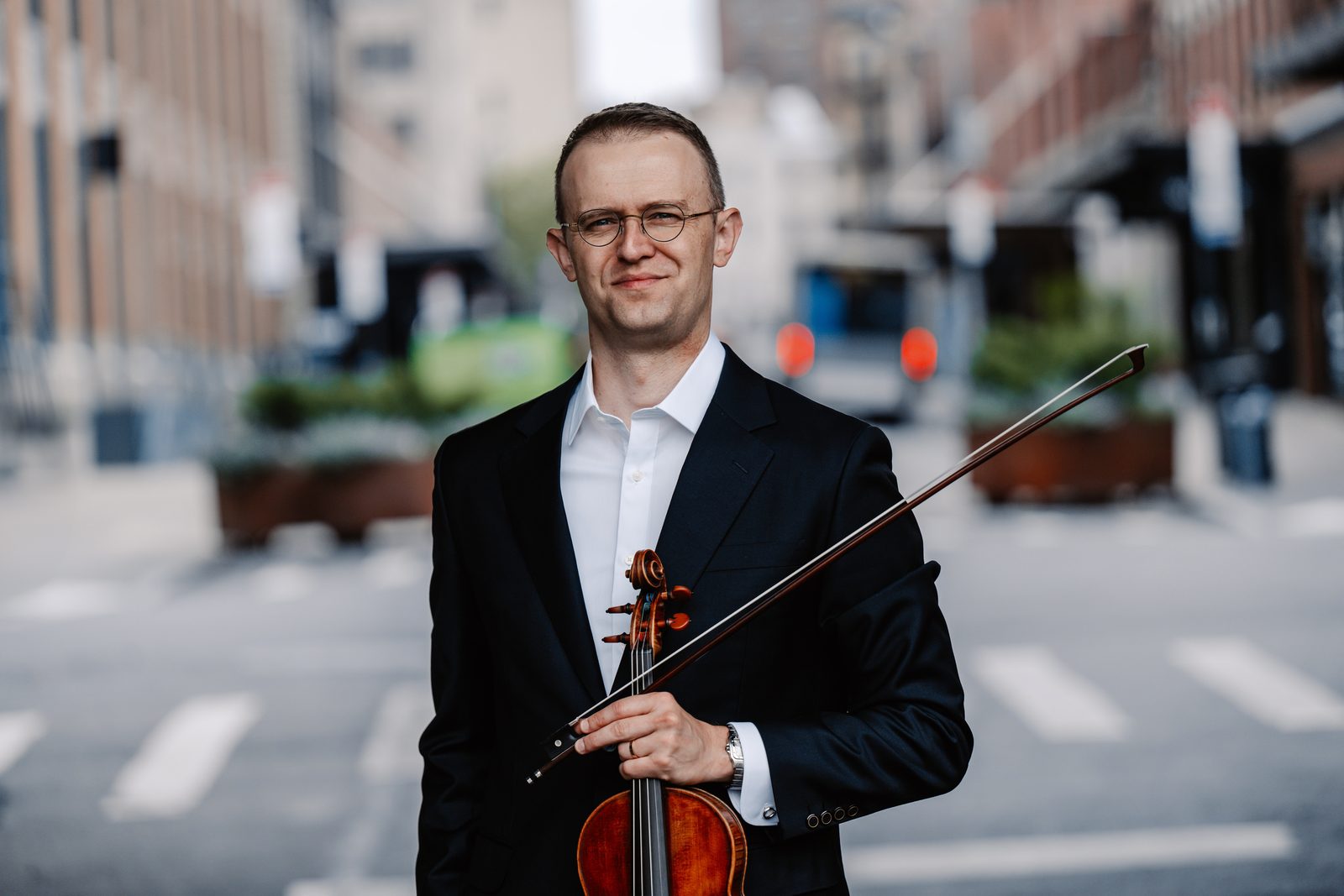 David Southorn with violin and bow on a city street