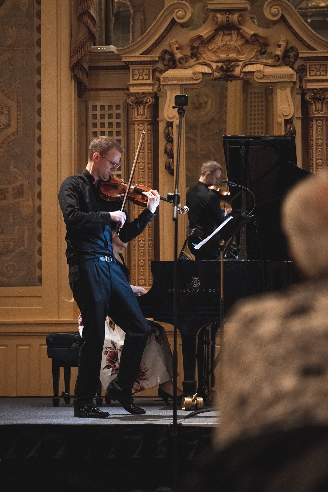 David Southorn performing on stage with a pianist at a grand piano